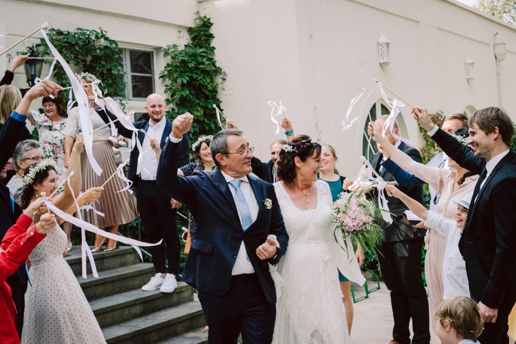 guests receiving bride and groom after the wedding ceremony