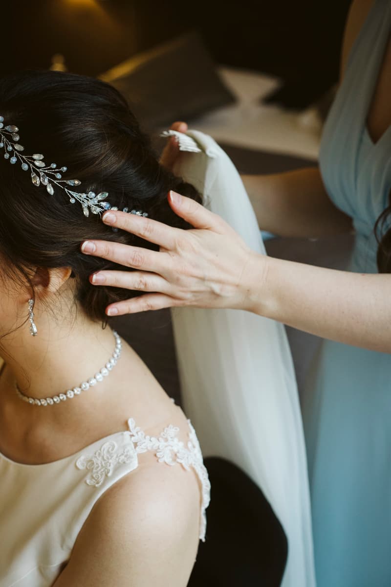 Bride's hair is made for the wedding ceremony in her room at Gästehaus Blumenfisch Berlin